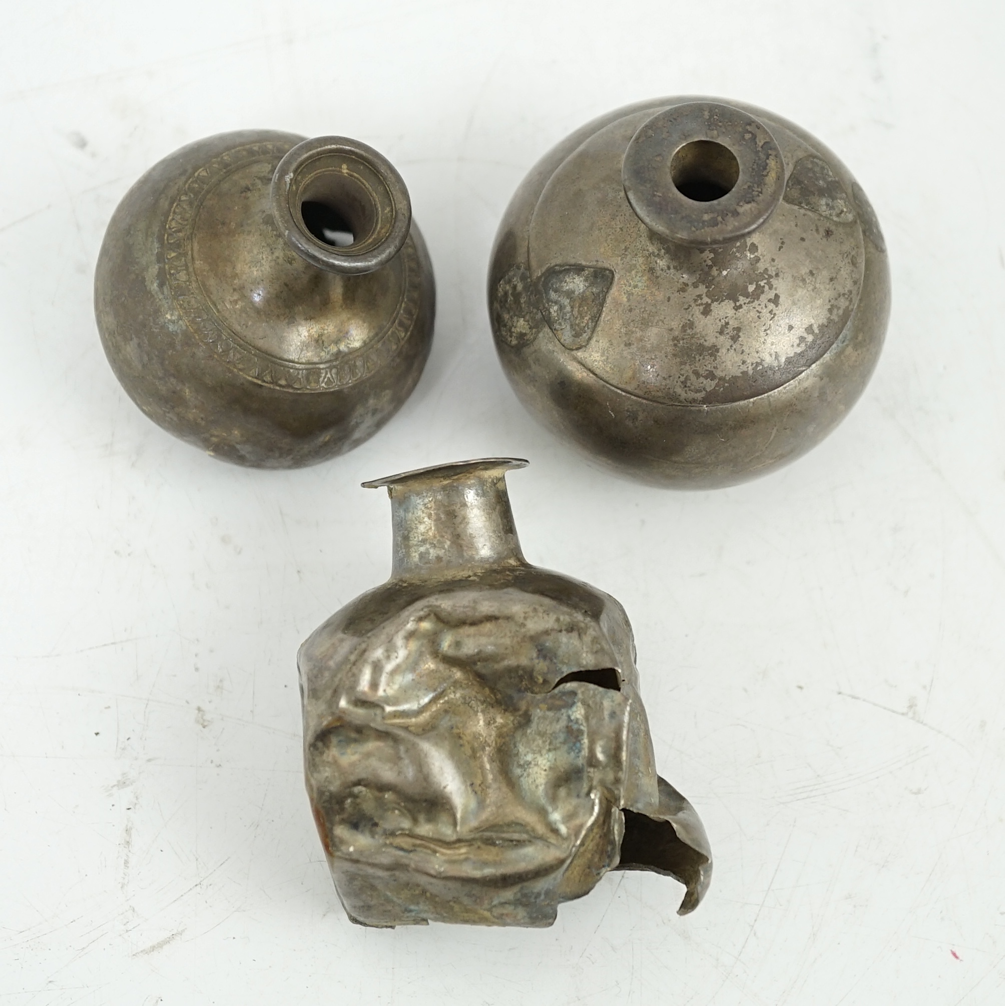 Three silver aryballoi, incomplete, Roman or Gandhara, c. late 1st century BC - early 1st century A.D.